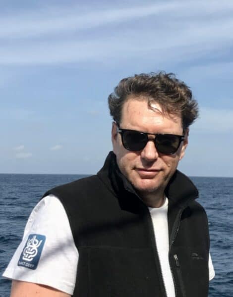 Oceanic Society naturalist, Benjamin Kahn posing in front of open water