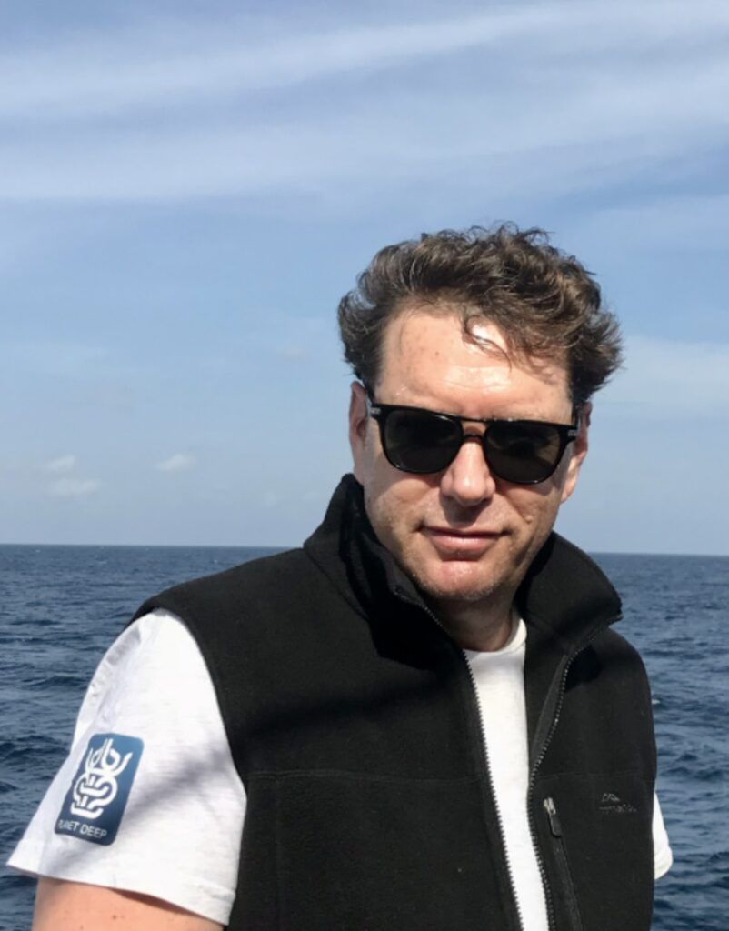 Oceanic Society naturalist, Benjamin Kahn posing in front of open water