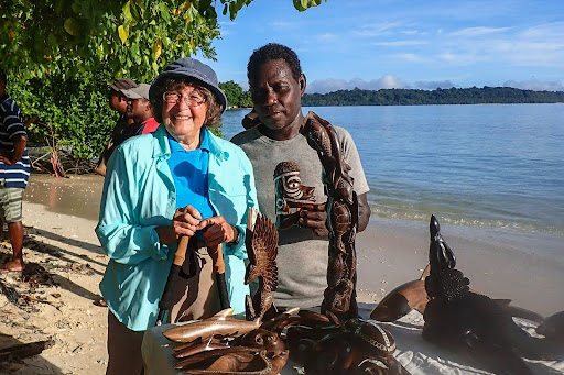 traveler meeting Solomon Island wood carver