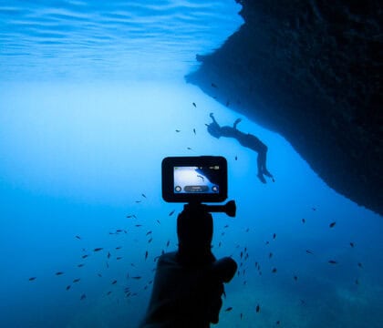 GoPro camera in waterproof housing capturing underwater marine adventures, perfect for snorkeling, diving, or ocean exploration.