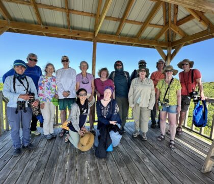 Solo travelers pose together on an Oceanic Society expedition in Belize, smiling and enjoying the experience as a group.