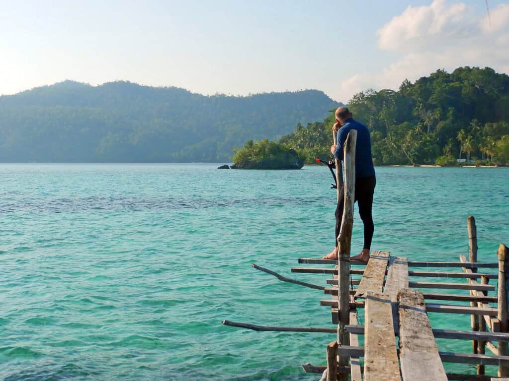 man on a pier in Raja Ampat Indonesia
