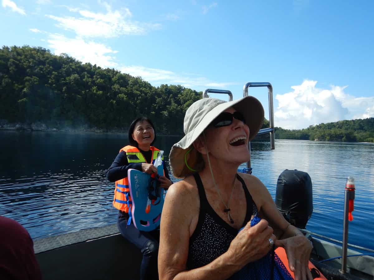 Oceanic Society traveler laughing with guests aboard zodiak