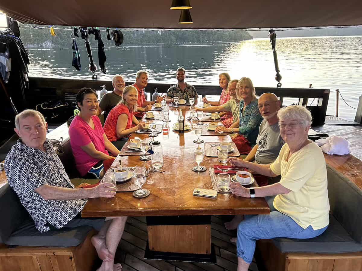 Oceanic Society travelers having meal together aboard liveaboard ship in Raja Ampat
